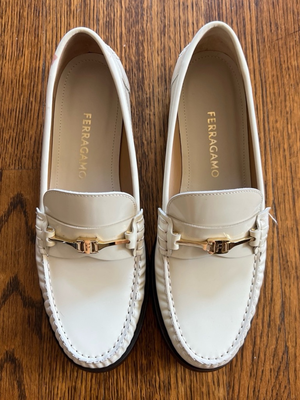 Ferragamo Ivory Patent Loafers with horse bit buckle detailing. Size 8.